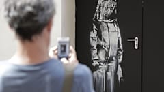 A work by controversial British artist known as Banksy, entitled 'Riot Green', on show at the Andipa Gallery in London Wednesday, Feb. 27, 2008.