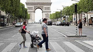 People stroll on the Champs Elysees avenue in Paris, Wednesday, June 3, 2020.
