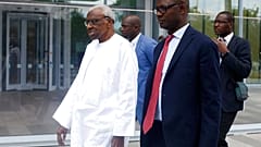 Former president of the IAAF (International Association of Athletics Federations) Lamine Diack, left, arrives at the Paris courthouse, Wednesday, June 10, 2020