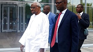 Former president of the IAAF (International Association of Athletics Federations) Lamine Diack, left, arrives at the Paris courthouse, Wednesday, June 10, 2020