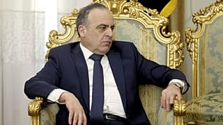 Syrian Prime Minister Imad Khamis listens to Secretary of Iran's Supreme National Security Council Ali Shamkhani in a meeting in Tehran, Iran.