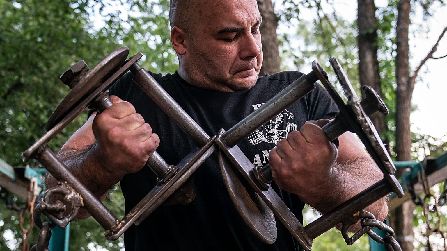 A man trains in the outdoor gym on Dolobetskyi island in the Dnieper River in Kyiv, Ukraine