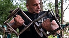 A man trains in the outdoor gym on Dolobetskyi island in the Dnieper River in Kyiv, Ukraine
