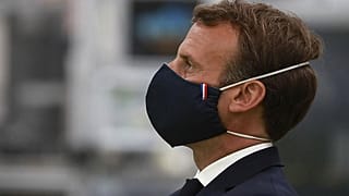 Il Presidente francese, Emmanuel Macron, indossa una mascherina realizzata da un'azienda francese durante la sua visita ad uno stabilimento a Etaples