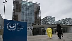 Supporters of former Ivory Coast President Laurent Gbagbo walk towards the International Criminal Court in The Hague, Netherlands, Wednesday, Jan. 16, 2019