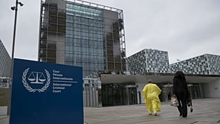 Supporters of former Ivory Coast President Laurent Gbagbo walk towards the International Criminal Court in The Hague, Netherlands, Wednesday, Jan. 16, 2019