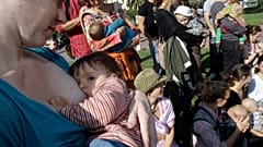 Mothers feed their children during the first day of the 6th World Breastfeeding Week