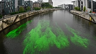 A part of the River Spree next to the Reichstag building is coloured green by the activists to protest the German government's coal policies. Berlin, Germany. 11 June 2020