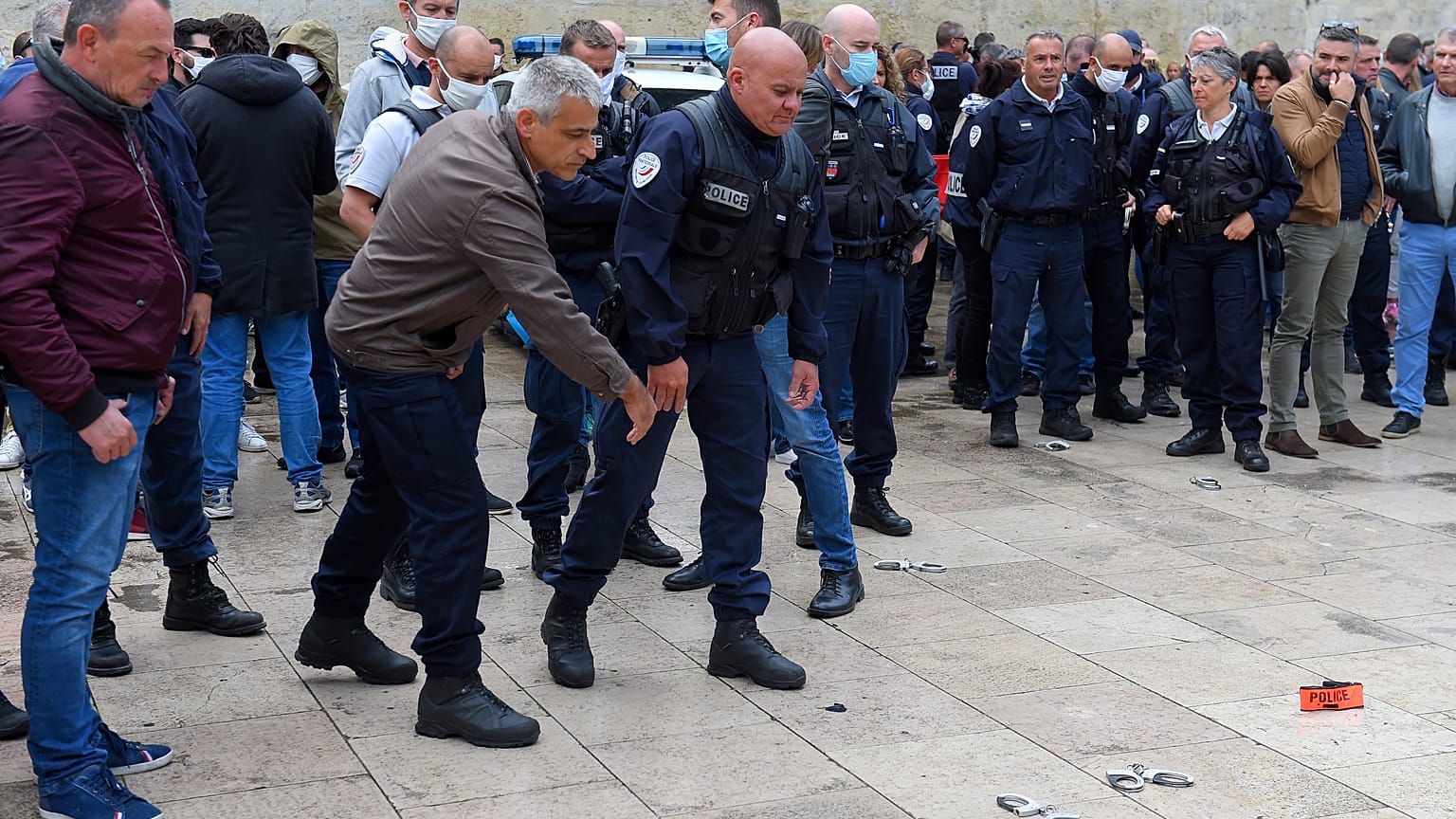 French police throw handcuffs and arm band on the ground following demonstrations against police brutality and racism. 