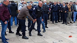 French police throw handcuffs and arm band on the ground following demonstrations against police brutality and racism.