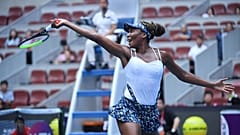 Venus Williams of the US hits a return against Barbora Strycova of the Czech Republic in their women's singles first round match at the WTA China Open tennis tournament.