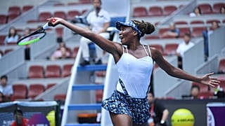 Venus Williams of the US hits a return against Barbora Strycova of the Czech Republic in their women's singles first round match at the WTA China Open tennis tournament.