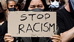 Una donna mostra un cartello "Stop al razzismo", durante a una manifestazione a Berlino (06/06/2020)
