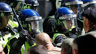 British police officers in riot gear scuffle with members of far-right groups protesting against a Black Lives Matter demonstration, in central London, Saturday, June 13, 2020