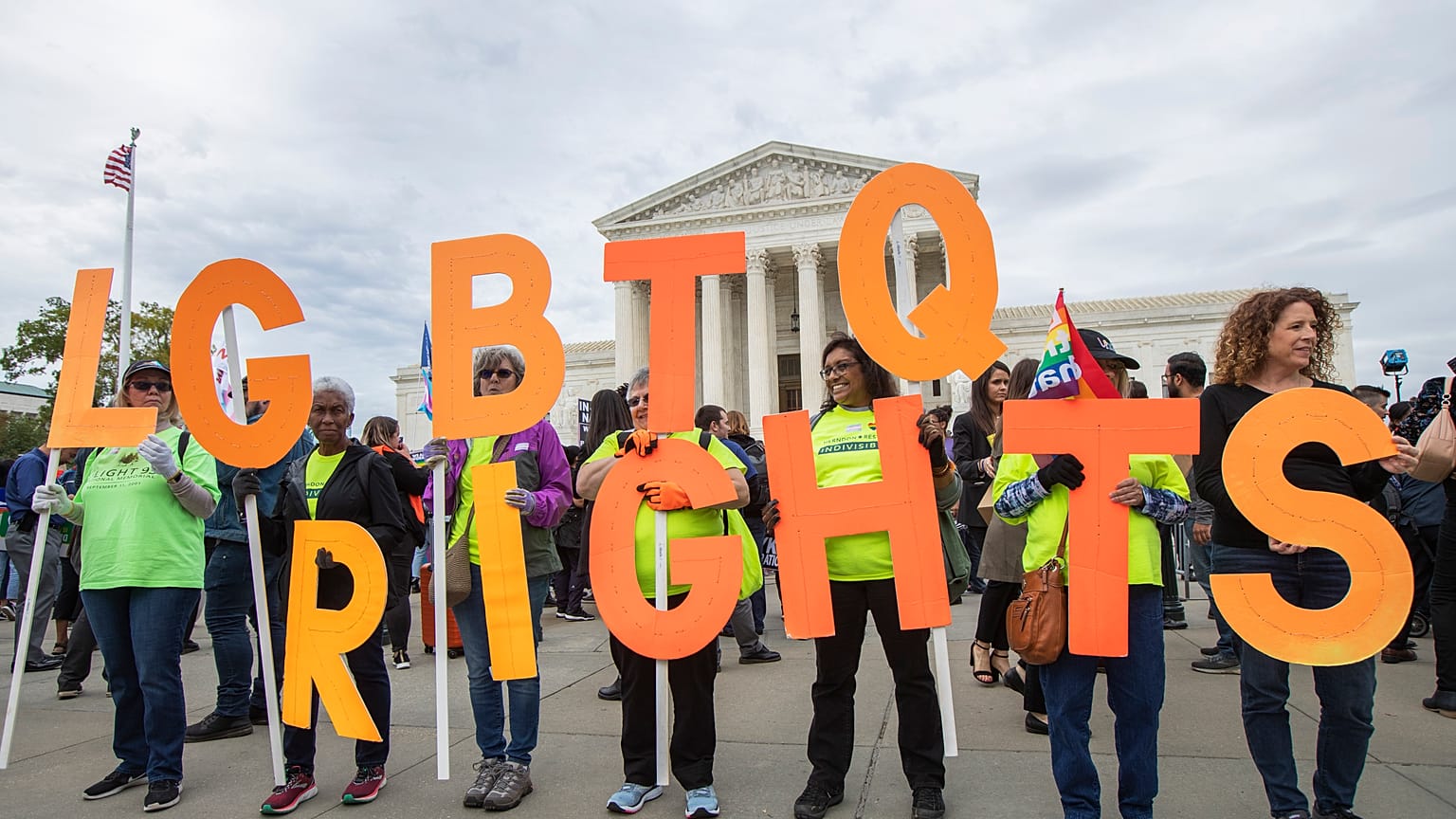 FILE - In this Oct. 8, 2019, file photo, supporters of LGBTQ rights hold placards in front of the U.S. Supreme Court in Washington.