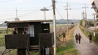 South Korean army soldiers patrol along the barbed-wire fence in Paju, South Korea, near the border with North Korea