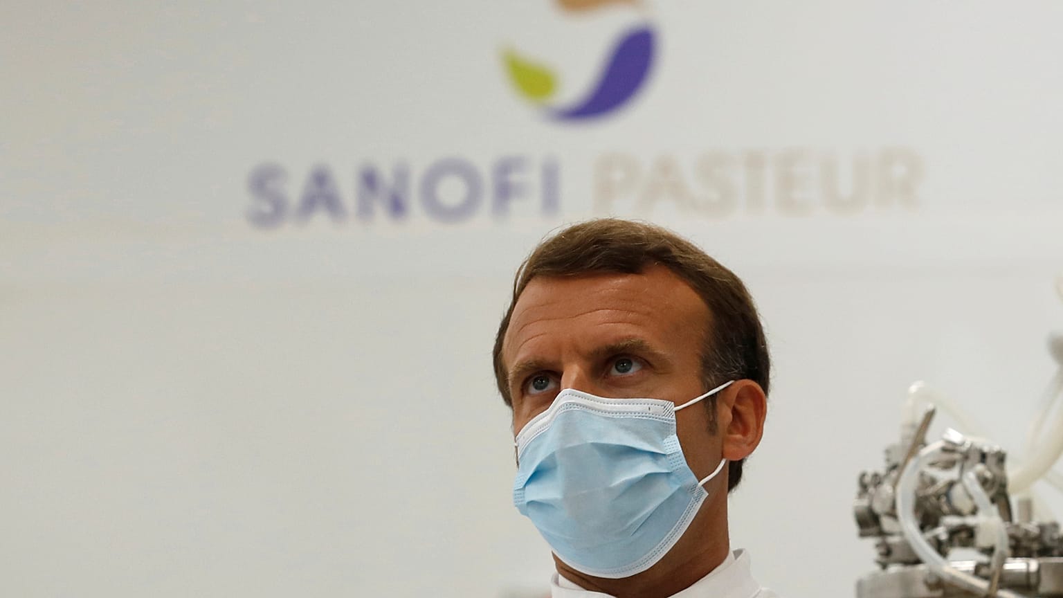 French President Emmanuel Macron visits an industrial development laboratory at the French drugmaker's vaccine unit Sanofi Pasteur plant in Marcy-l'Etoile, near Lyon.