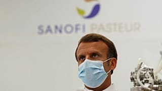 French President Emmanuel Macron visits an industrial development laboratory at the French drugmaker's vaccine unit Sanofi Pasteur plant in Marcy-l'Etoile, near Lyon.