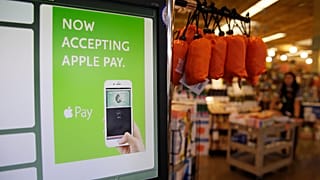 In this photo taken Friday, Oct. 17, 2014, a cash register terminal promotes usage of the new Apple Pay mobile payment system at a Whole Foods store in Cupertino, Calif. 