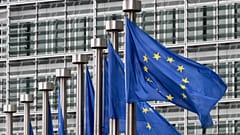 EU flags flutter outside the European Commission in Brussels.
