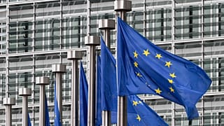 EU flags flutter outside the European Commission in Brussels.