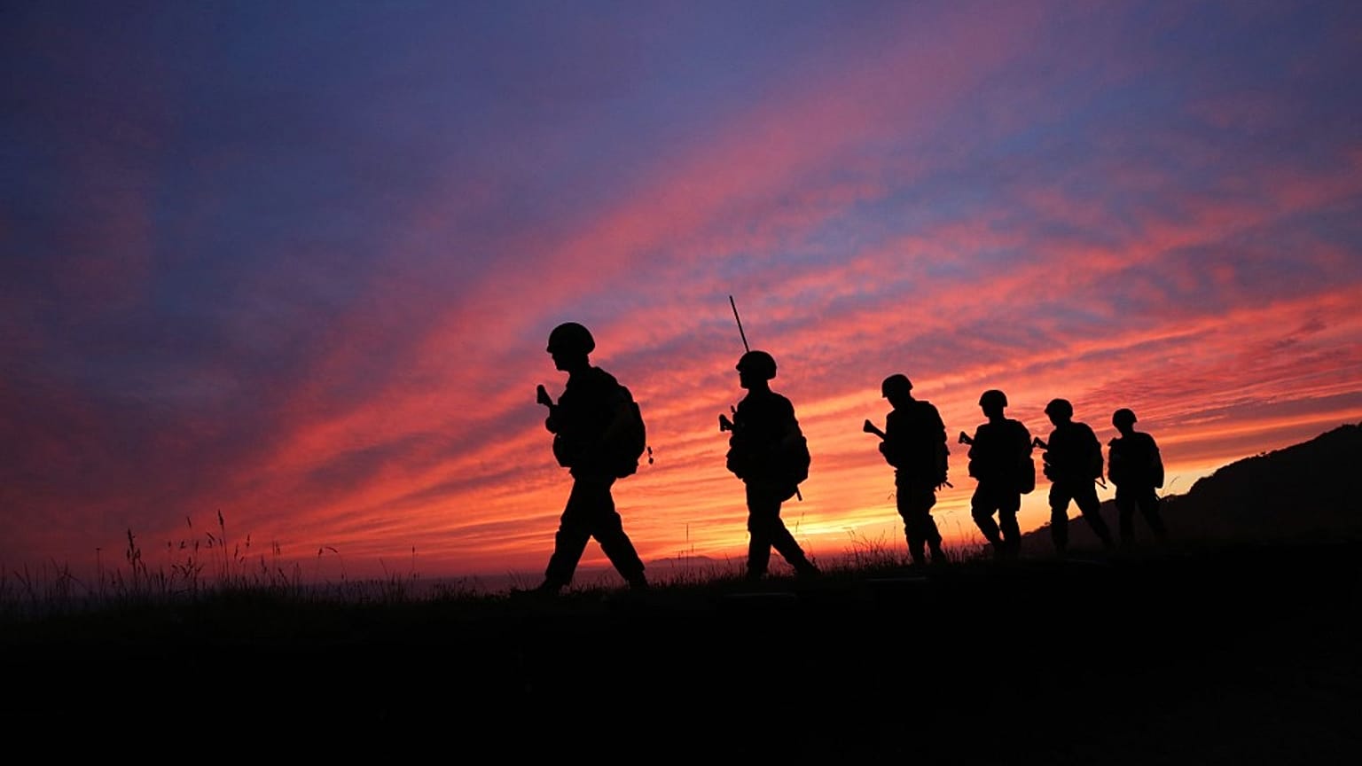 South Korean marines patrol during sunset on the South Korea-controlled island of Yeonpyeong near the 'northern limit line' sea boundary with North Korea on June 16, 2020
