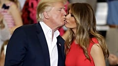President Donald Trump kisses his wife, first lady, Melania Trump