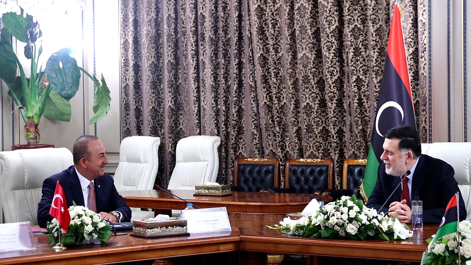 Turkey's Foreign Minister Mevlut Cavusoglu, right, and Fayez Sarraj