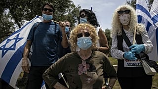 Supporters of Prime Minister Benjamin Netanyahu wear a masks, Israel