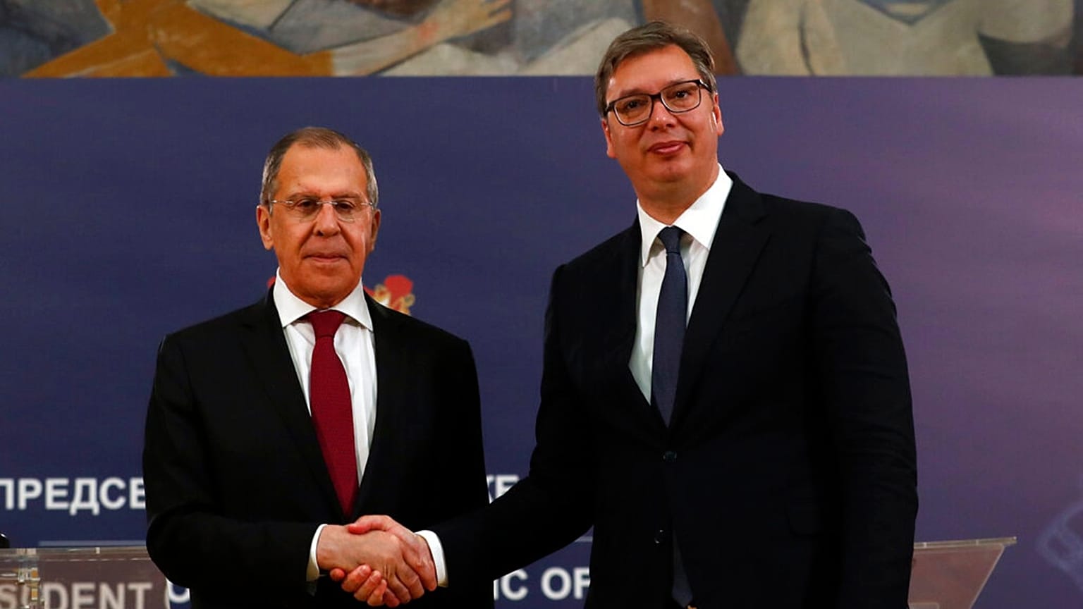Russian Foreign Minister Sergey Lavrov, left, shakes hands with Serbia's President Aleksandar Vucic after a joint press conference in Belgrade, Serbia, Thursday, June 18, 2020