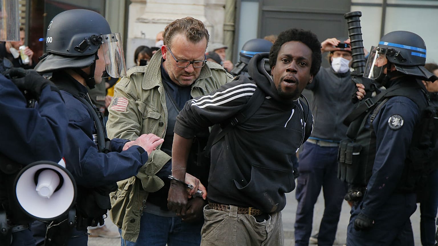 A protester is detained during an anti-racism demonstration, Thursday, June 4, 2020 in Lille, northern France