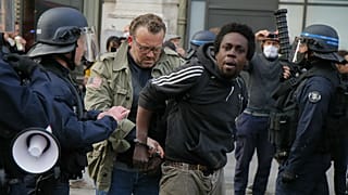 A protester is detained during an anti-racism demonstration, Thursday, June 4, 2020 in Lille, northern France