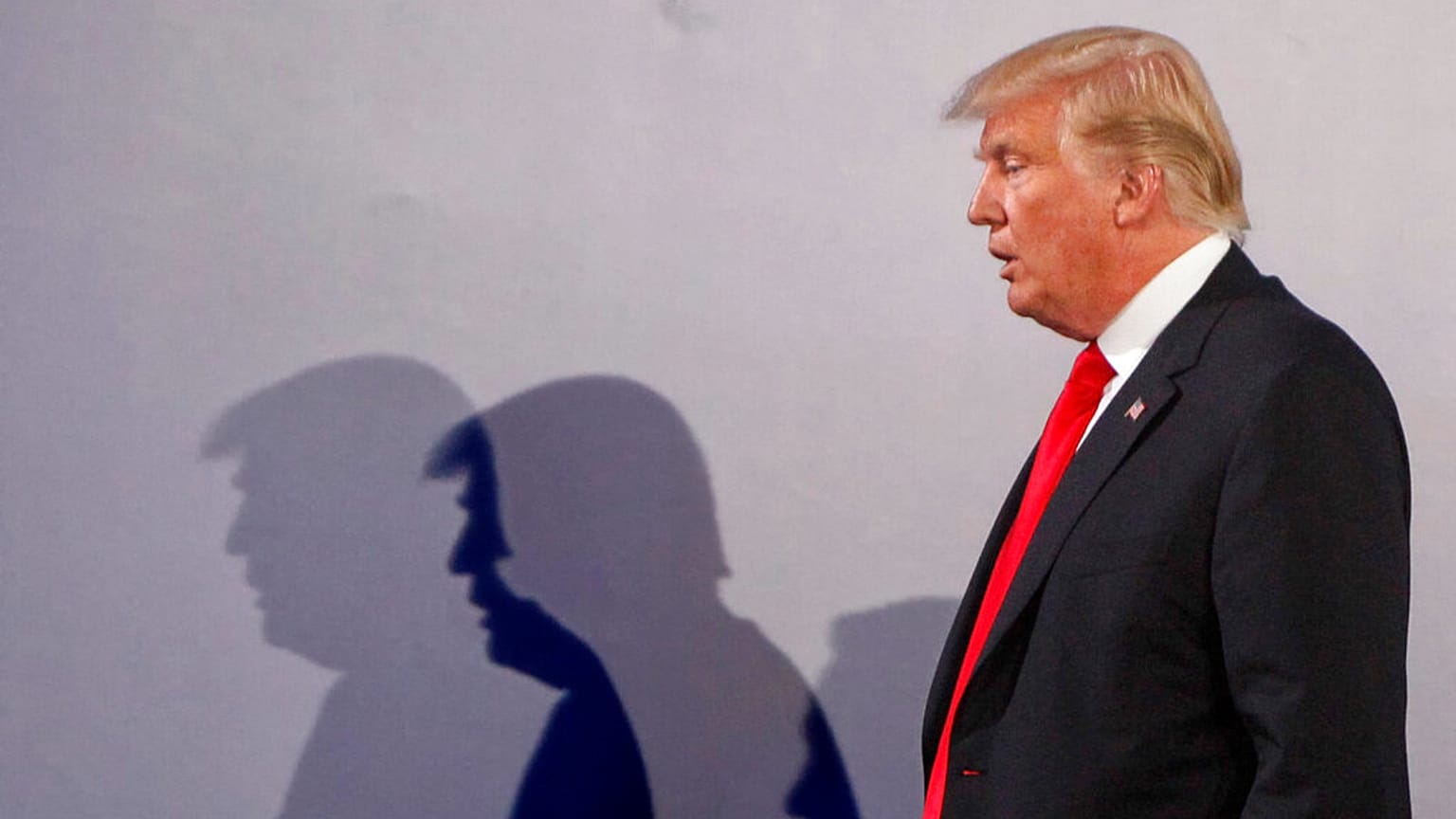 File - US President Donald Trump casts shadows on the wall after a press conference, in Warsaw, Poland, July 6, 2017