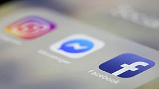 FILE- In this March 13, 2019, file photo Facebook, Messenger and Instagram apps are are displayed on an iPhone