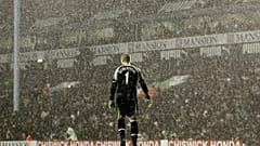 Tottenham Hotspur's goalkeeper Paul Robinson stands alone in the pouring rain during a Premier League match against Liverpool in 2006.