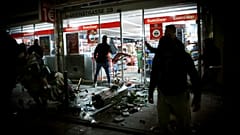Goods lie on the floor after people broke into a shop on Marienstrasse in Stuttgart, Germany, Sunday, June 21, 2020.
