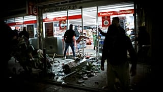 Goods lie on the floor after people broke into a shop on Marienstrasse in Stuttgart, Germany, Sunday, June 21, 2020.