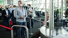Passengers, wearing face masks to protect against the spread of coronavirus, queue up to board their plane at the Zaventem international airport. Brussels, Belgium