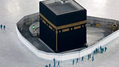 workers disinfect the ground around the Kaaba