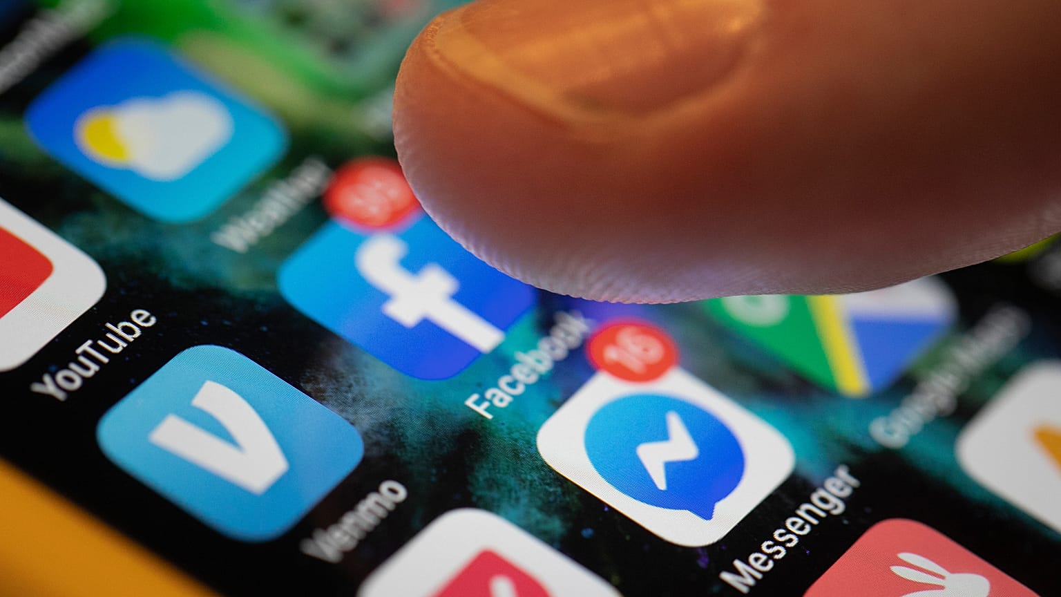 An iPhone displays the apps for Facebook and Messenger.