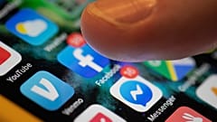 An iPhone displays the apps for Facebook and Messenger.