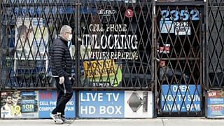 A man walks by a closed store during the COVID-19 in Chicago