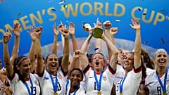 United States' Megan Rapinoe lifts up a trophy after winning the Women's World Cup final soccer match between US and The Netherlands at the Stade de Lyon, France