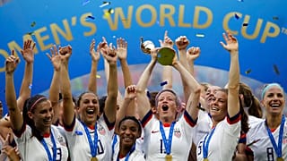 United States' Megan Rapinoe lifts up a trophy after winning the Women's World Cup final soccer match between US and The Netherlands at the Stade de Lyon, France