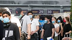Passengers wearing face masks to protect against coronavirus pass check-in procedure at Boryspil International Airport outside Ukraine's capital Kyiv