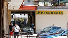 Police officers patrol an apartment complex area, Mondragone, Campania, Friday, June 26, 2020.
