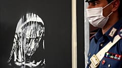 Italian police guard the recovered Banksy's artwork in L'Aquila, Italy, Thursday June, 11, 2020