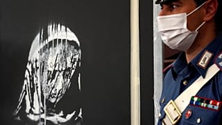 Italian police guard the recovered Banksy's artwork in L'Aquila, Italy, Thursday June, 11, 2020