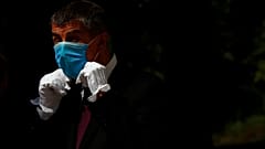 Czech Republic's Prime Minister Andrej Babis adjusts his face mask as he waits for the arrival of his Slovak counterpart Igor Matovic in Prague, Czech Republic, June 3, 2020