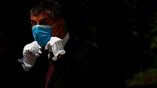 Czech Republic's Prime Minister Andrej Babis adjusts his face mask as he waits for the arrival of his Slovak counterpart Igor Matovic in Prague, Czech Republic, June 3, 2020